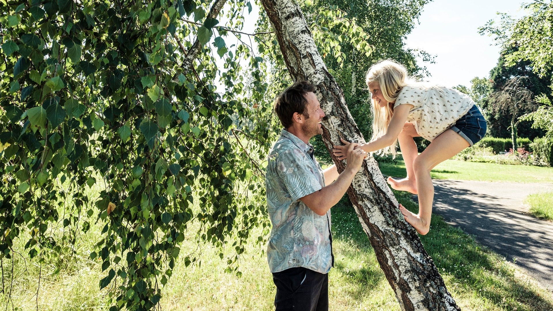 father-helping-daughter-climbing-a-birch-trunk-in-2024-09-17-05-19-44-utc